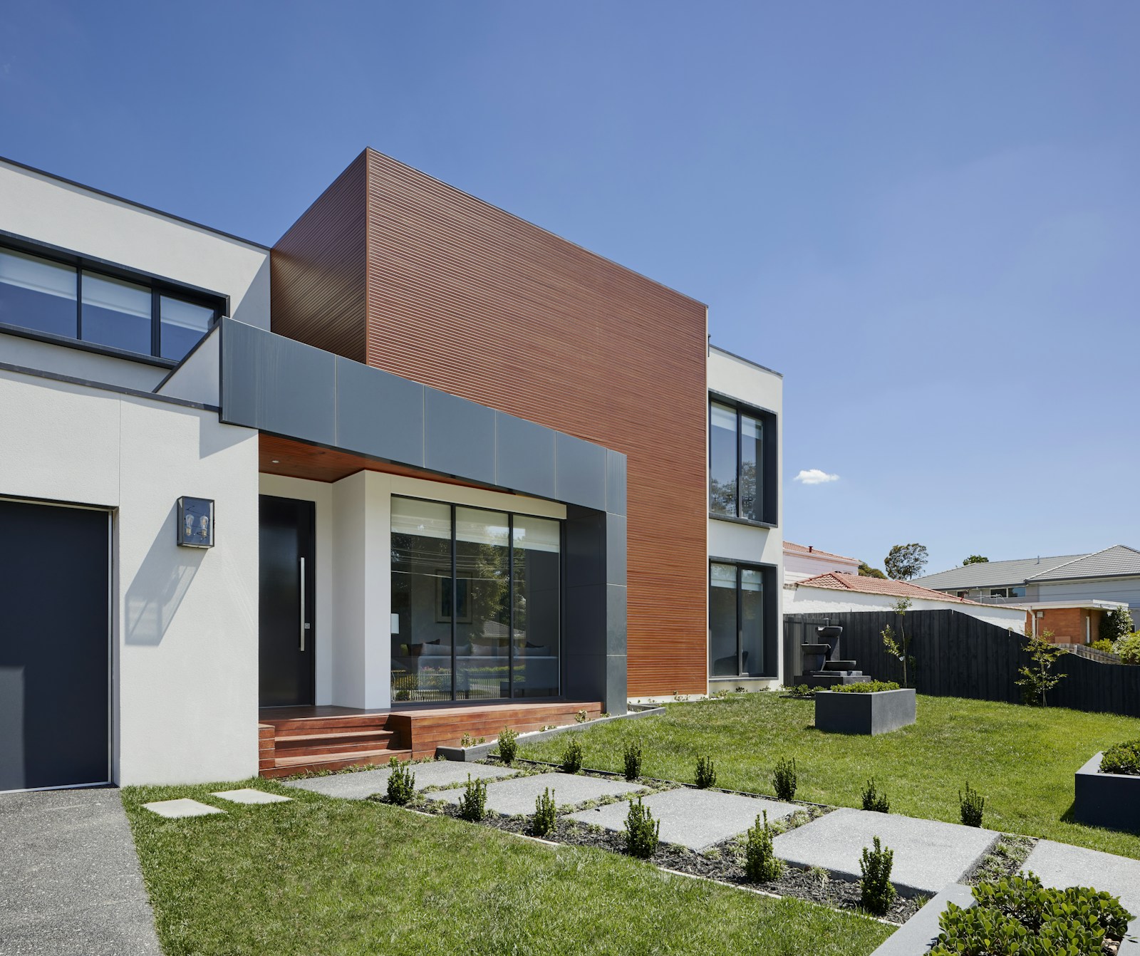 Modern white and wood exterior with black-framed windows